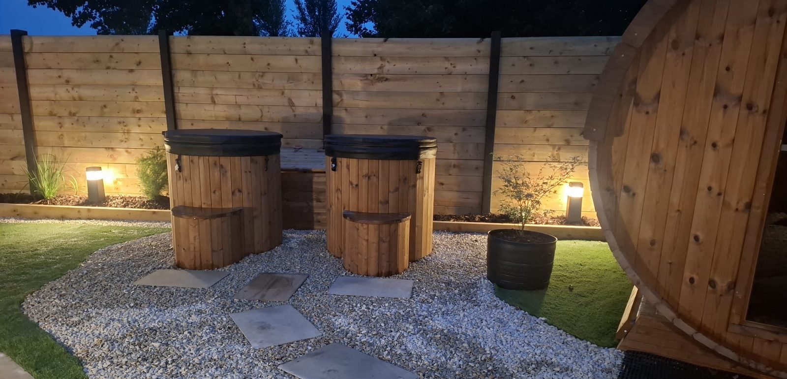 Wooden cold plunge tubs at dusk at B & M Saunas