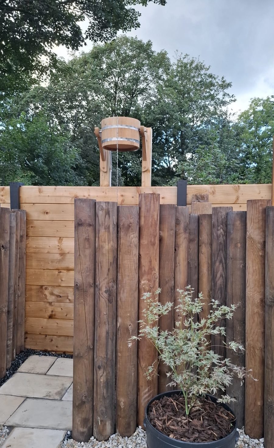 Wooden dousing bucket shower at B & M Saunas