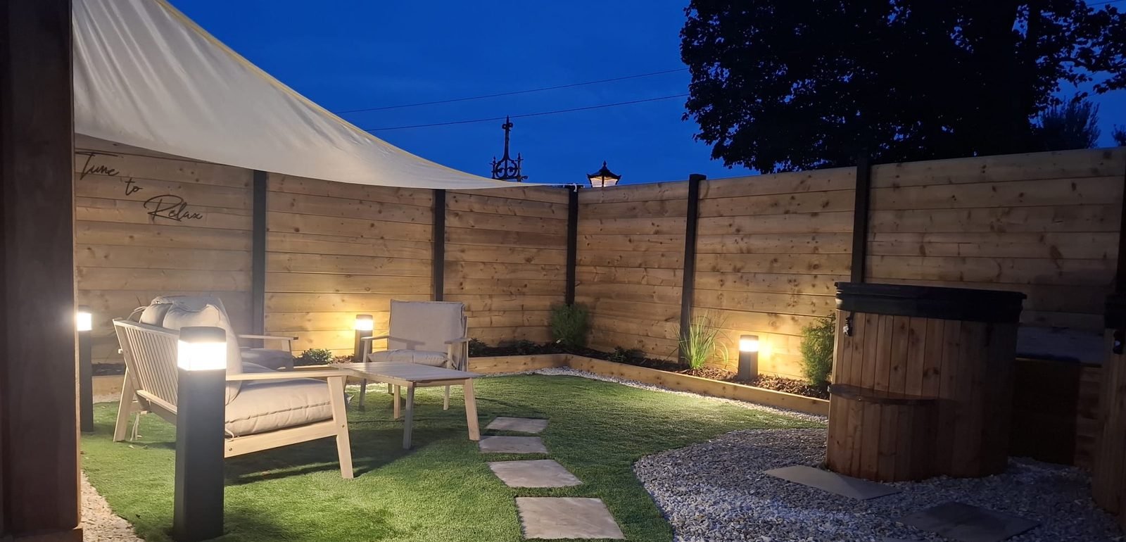 Lounge and cold plunge area at dusk at B & M Saunas